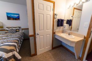 Bed and sink area at Peaks Lodge in Revelstoke, BC