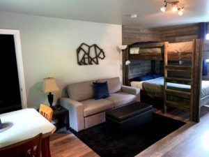 Bunk beds, sitting and dining area at Peaks Lodge in Revelstoke, BC