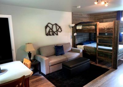 Bunk beds, sitting and dining area at Peaks Lodge in Revelstoke, BC