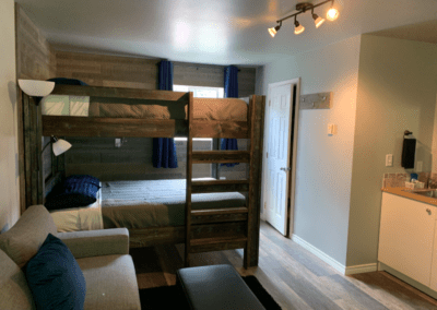 Kitchenette, bunks and sitting area at Peaks Lodge in Revelstoke, BC